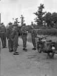 Brigadier J.D.B. Smith talking with Private J.A. Braconnier, a despatch rider with the 10th Canadian Infantry Brigade, Rijssen, Netherlands, 30 May 1945 May 30, 1945.