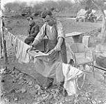 Private James Sproul of the 10th Field Regiment, Royal Canadian Engineers (R.C.E.), hanging washing on the line, Castel Frentano, Italy, 20 December 1943 December 20, 1943