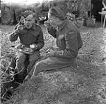 Sappers F.R. Fuller and Harry Rennie of the Royal Canadian Engineers (R.C.E.) eating dinner, Castel Frentano, Italy, 20 December 1943 December 20, 1943.