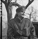 L/Cpl. G.S. Fehr, 8 Reconnaissance Regiment (Recce) wearing a Daniel Boon hat made from a German salvaged neck piece. Xanten (vic.), Germany, 10 mar. 1945 10 MAR. 1945