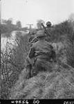 Infantry of the South Saskatchewan Regiment moving along the canal 12 Apr. 1945