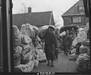 Christmas mail being unloaded by men of the Pioneer Corps at the 2 Canadian Corps Army Post Office. Oss, Netherlands, 6 Dec. 1944 6 DEC. 1944