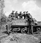 Infantrymen of "D" Company, The Seaforth Highlanders of Canada, with their Universal Carrier, which is inscribed "Germany Kaput - Italia Tutto Finito - Here We Come Canada", De Glindhorst, Netherlands, 5 May 1945 May 5, 1945.