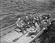 Canadian soldiers in a storm boat at the 5th Canadian Armoured Division Other Ranks Club, Groningen, Netherlands, 10 August 1945 August 10, 1945.
