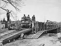 Vehicles and personnel of the Stormont Dundas and Glengarry Highlanders of Canada crossing a Bailey Bridge over the Schip Beek Canal. Bathmen, Netherlands, 9 April 1945 9 Apr. 1945