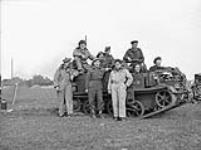 Personnel of the Machine Gun Platoon, Cameron Highlanders of Ottawa (M.G.), with a Universal Carrier, on the Rhine River west of Rees, Germany, 26 March 1945 Marh 26, 1945.