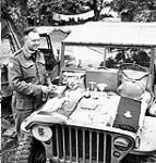 H/Major John W. Forth, Chaplain of The Cameron Highlanders of Ottawa (M.G.), displaying his field Communion set near Caen, France, 15 July 1944 July 15, 1944.