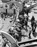 A wounded Royal Navy Beach Commando being taken aboard H.M.C.S. PRINCE DAVID off the Normandy beachhead, France, 6 June 1944 June 6, 1944.