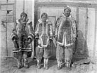 [Inuit family standing in front of building. The man on the right has been identified as Paul Roche], Blacklead Island, N.W.T. [[Nunavut]], 2 September 1911 September 2, 1911.