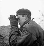 Lieutenant Louis Woods of Le Régiment de Maisonneuve observing a German position during Operation VERITABLE near Nijmegen, Netherlands, 8 February 1945 February 8, 1945.
