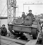 A Universal Carrier of the 14th Canadian Hussars being loaded aboard a barge en route from South Beveland to North Beveland, Netherlands, 1 November 1944 November 1, 1944.