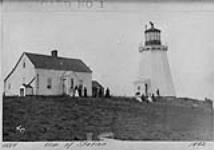 View of station, Cape Breton, showing lighthouse tower and dwelling. Several couples seen on grounds 1892