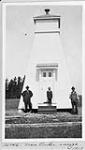 Outer range tower with two unidentified men and a young boy near entrance 1917