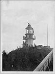 Lighthouse tower near completion (workers on scaffolding) July 1909