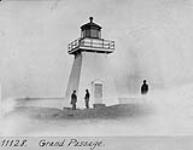 Light tower and three men nearby c.a. 1890