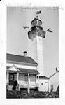 Little Métis lighthouse and tower, seen from the southwest. Lightkeeper's residence in foreground June 1935