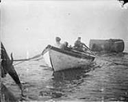 Towing boiler ashore with surf boat 1898