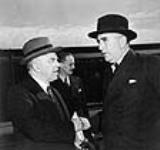 Rt. Hon. W.L. Mackenzie King (left) saying goodbye to Rt. Hon. R.G. Menzies at Union Station. Mr. W. Howard Measures is in the background 8 May 1941