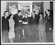 Jewish Labour Committee's display at the 62nd Annual Convention of the Trades and Labour Congress. (L-R): O. Renaud, --, Claude Jodoin, Robert Brown, --, Kalmen Kaplansky, L.E. Wismer Sept-Oct 1947