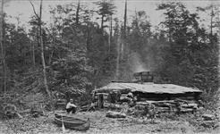 Lumbermen's Shanty. A. Henderson's portable photographic dark room in front of the shanty ca. 1879