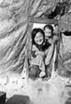 [Mona Tigitkok with baby Adam Katiek.] 1949-1950