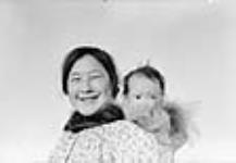 [Mona Tigitkok with baby Adam Katiek.] 1949-1950