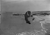 Canada: Snow House [Man building an igloo] [graphic material] 1933