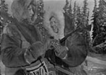 [Two Indigenous women hunting, wearing their traditional parkas]. Original title: Women hunting in eskimo parkas [graphic material] 1933