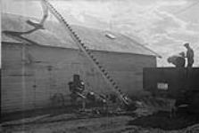 A miniature elevator which brings the grain from the van to the granary, Manitoba [graphic material] 1933.