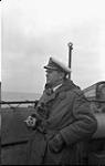 Commander J.D. Prentice, Commanding Officer, on the bridge of the corvette H.M.C.S. CHAMBLY at sea, 24 May 1941 May 24, 1941.