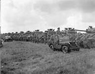 Tank crews of The British Columbia Dragoons lined up in front of their Sherman tanks during a review by General H.D.G. Crerar followed by a mounted marchpast, Eelde, Netherlands, 23 May 1945 May 23, 1945.