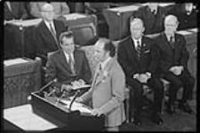Prime Minister Pierre Eliott Trudeau speaking in the House of Commons during President Nixon's visit to Canada - Mitchell Sharp behind P.E. Trudeau 1972