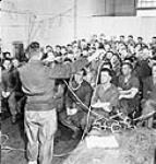 Major Rex Gibson demonstrating mountain-climbing knots during a lecture on mountaineering techniques to personnel of the Lovat Scouts 1944