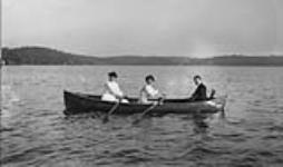 Three unidentified women in a rowboat ca. 1907