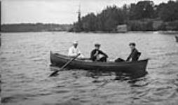 Three unidentified men in a rowboat ca. 1907