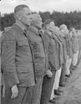 2nd Canadian Corps. Demobilization of high ranking Nazi officers and officials in internment camp. Close-up of German officers without their uniforms at end of platoon 8 June 1945