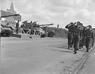 Troops of the 2 Canadian Army Corps marching past the saluting base where General Guy Simonds is taking the salute 31 May 1945