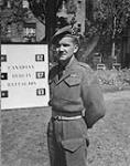 CANADIANS IN GERMANY. Maj. Robert D. Mackenzie 2nd in command of the Canadian Berlin Battalion in front of headquarters 20-Jul-45