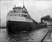 Close port bow view of laker CHARLES C. WEST of the Rockport Steamship Co. in canal 1925