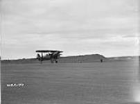Curtiss SBC Helldiver biplane aircraft taking off of unidentified airfield June 1940