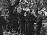 Infantrymen of The Royal Winnipeg Rifles searching German prisoners, Aubigny, France, ca.16-17 August 1944 [ca. August 16-17, 1944].