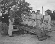 8th Field Regiment of the Royal Canadian Artillery receiving instructions during the Reserve Force summer exercises 03-Jul-50
