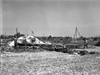 Artillery Observation aircraft of RAF Air Observation Squadron 661 being dug in at a forward air field. It is being covered with camouflage netting 31-Jul-44
