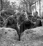 Officers of Cameron Highlanders of Ottawa of the 3rd Canadian Infantry Division holds map session under direction of Lieut. Col. P.C. Klaehn. Others are: Maj. R. Rowley, Maj. J.W. Forth, Capt. G.A.Harris, Capt. J. M. Lambert, Capt. R.F. Ferrie (see no 15-Jul-44