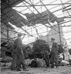 Unidentified Canadian officers examining a damaged Henschel Hs 129 aircraft of the Luftwaffe, Carpiquet, France, 12 July 1944 July 12, 1944.