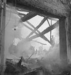 Personnel of the Royal Canadian Engineers extinguishing fire caused by German shelling 12-Jul-44