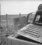 Canadian troops pass burned out German tank 09-Jul-44
