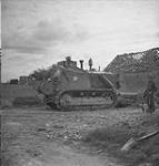Bulldozer in action widening the cross-roads immediately after it was cleared by the sappers of the Royal Canadian Engineers 09-Jul-44