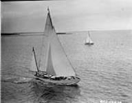Royal Canadian Navy yacht PICKLE: oblique view of starboard bow on training exercise with RCN yacht TUNA in background 4 Aug. 1955