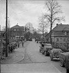 Lines of troops and transport of the No. 1 Canadian Parachute Battalion line the streets waiting for a bridge to be built 4 Apr. 1945